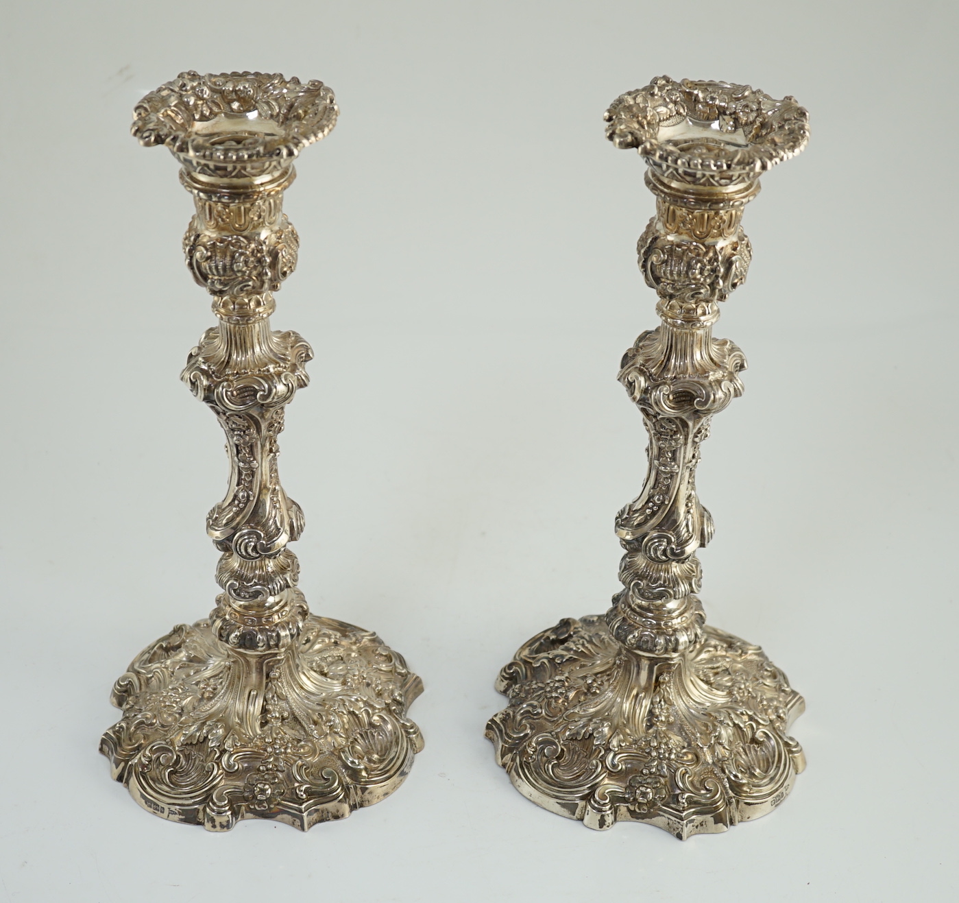 An ornate pair of Edwardian silver candlesticks, by Walker & Hall